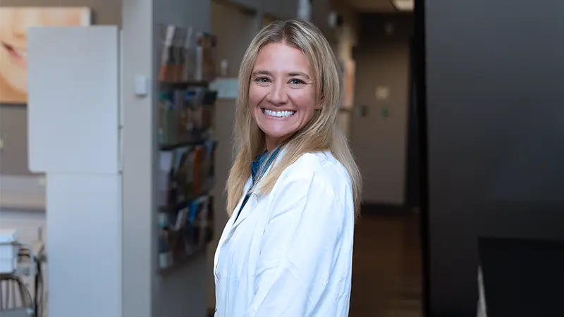Dr. Nikki Sparks, DDS standing in office smiling