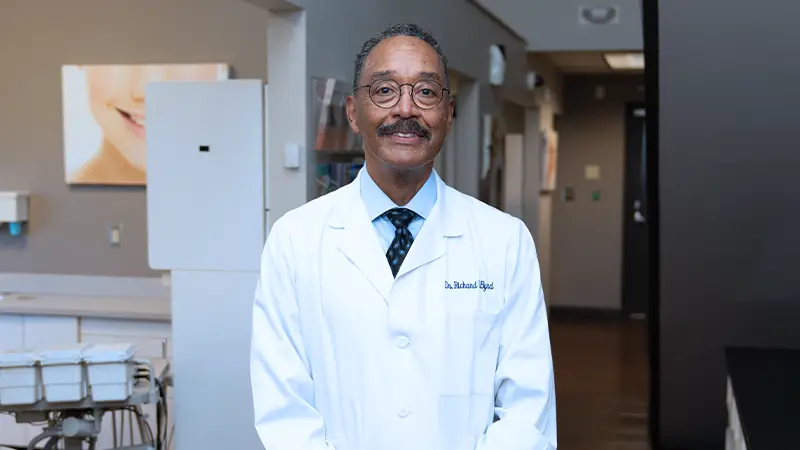 Dr. Richard Byrd, DDS standing in office