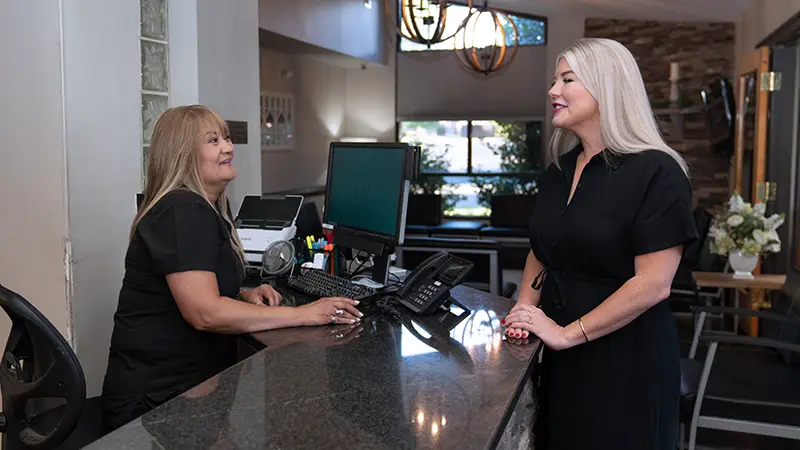 Client talking to front desk team member about payment options
