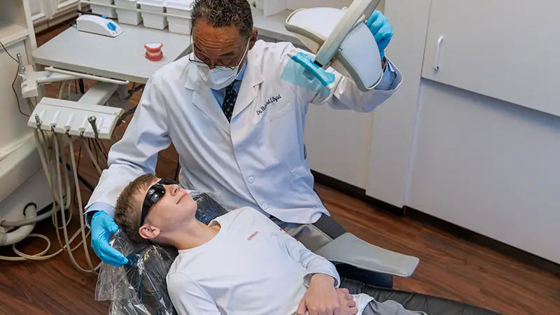 Othodontist examining patient